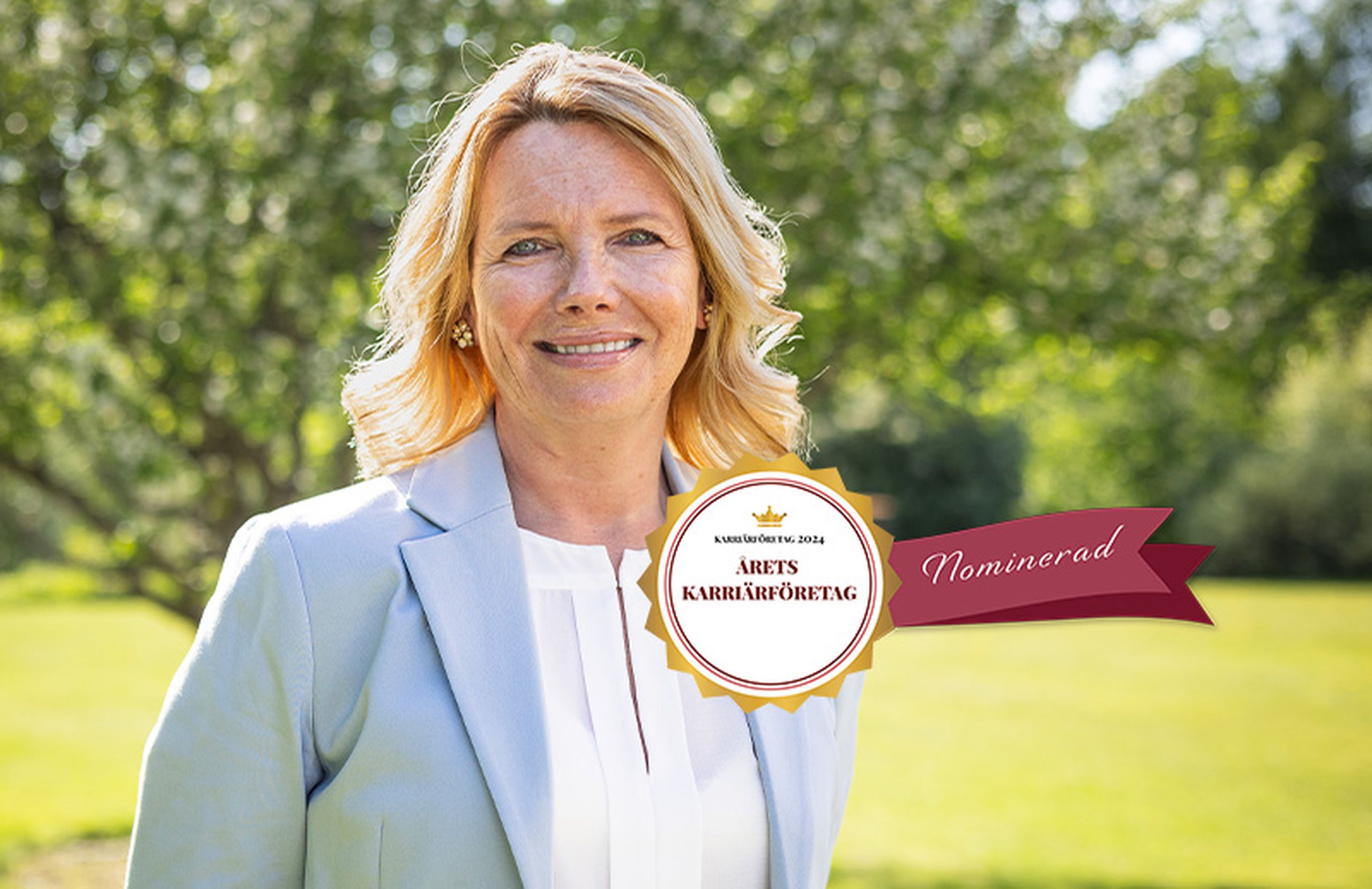 A female HR manager standing in a garden with a logo on it