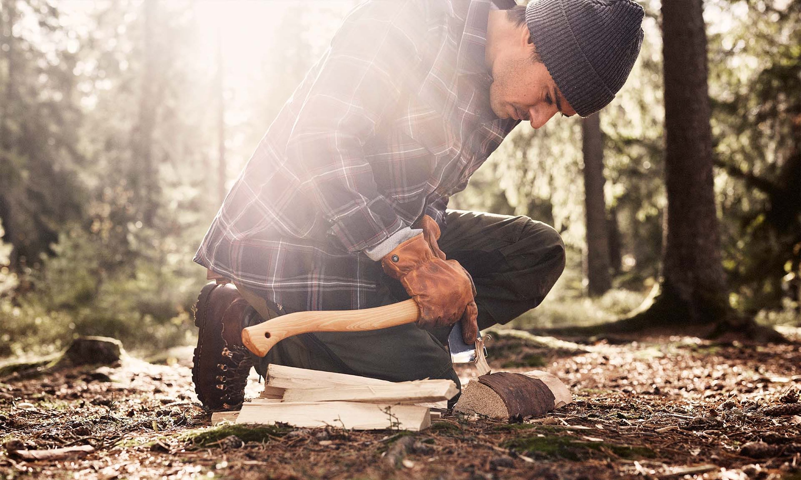 A person in the forest with a Hultafors axe with ovako steel in it